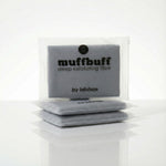 Gray exfoliating scrubber with 'muffbuff' branding on a white background