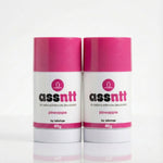 Two containers of 'assnnt' all natural intimate deodorant with pink caps on a white background.